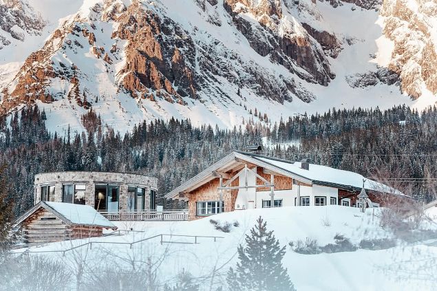 Image: Snow covered mountain and resort exterior of Übergossene Alm Resort.