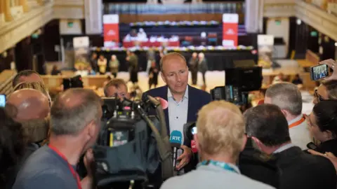 PA Media Tánaiste Micheál Martin speaks to a group of reporters in Cork City Hall 