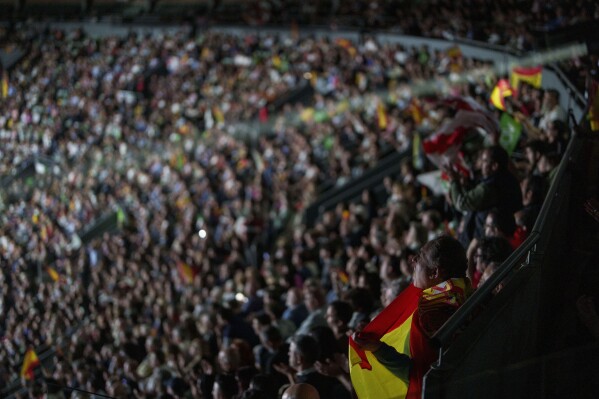 A supporter holds a Spansh flag during the Spanish far-right wing party Vox's rally 