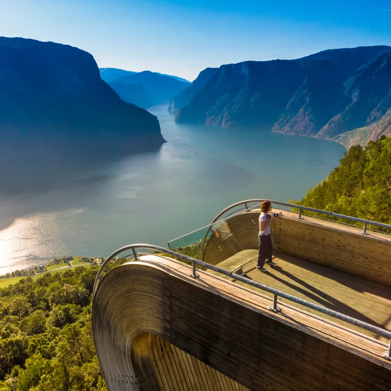 Tourist Taking A Picture In A Scenic Lookout In Aurlandsfjord In Norway, Scandinavia, Northern Europe