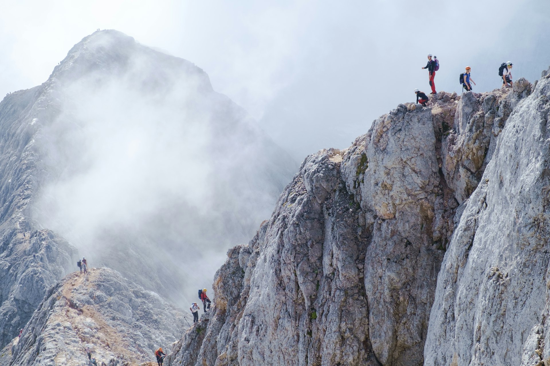 Climbers on the top of a jagged mountain trail