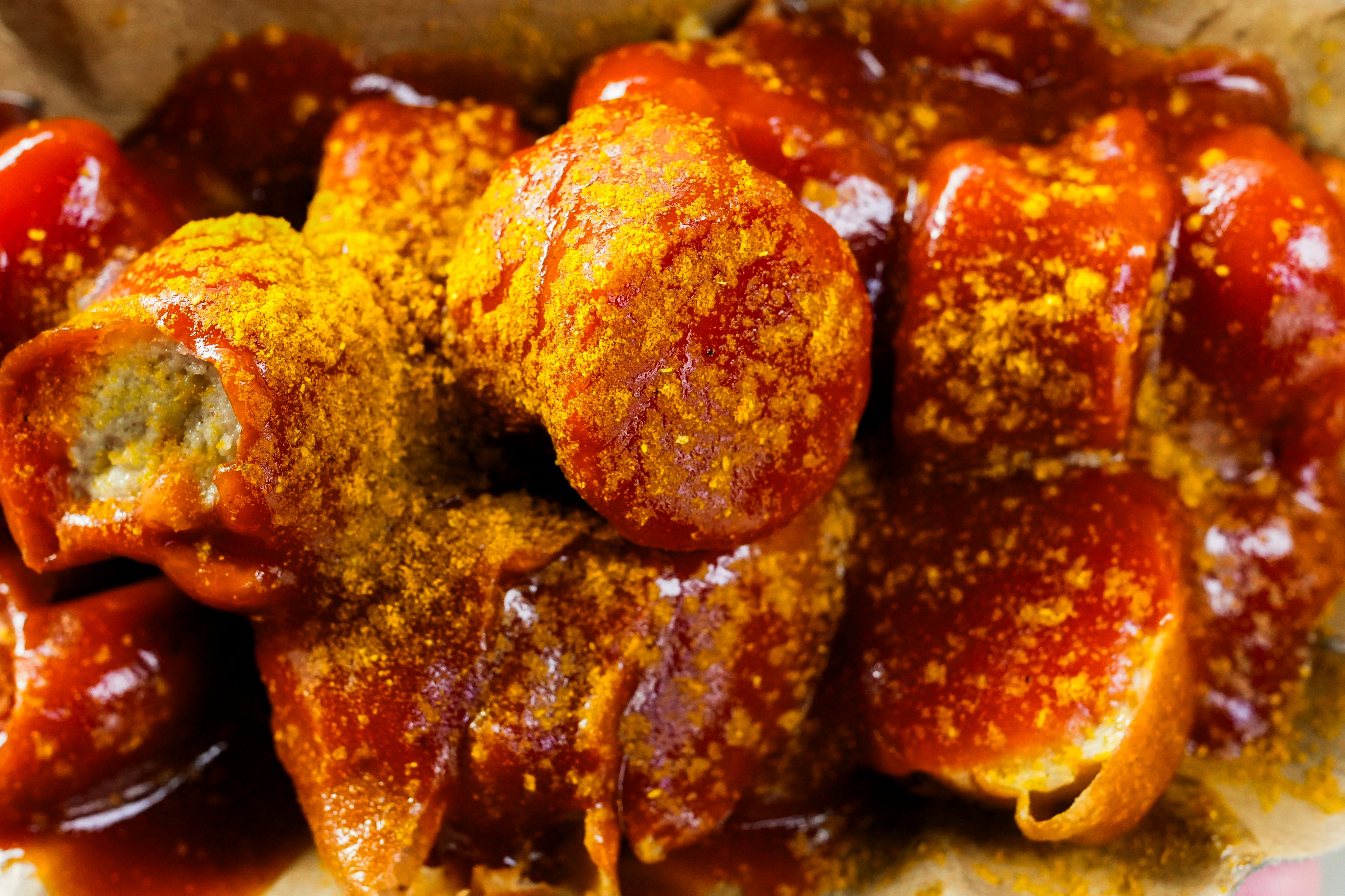 Currywurst, Germany’s sausage with curry sauce, served on a cardboard at Konnopke’s Imbiß