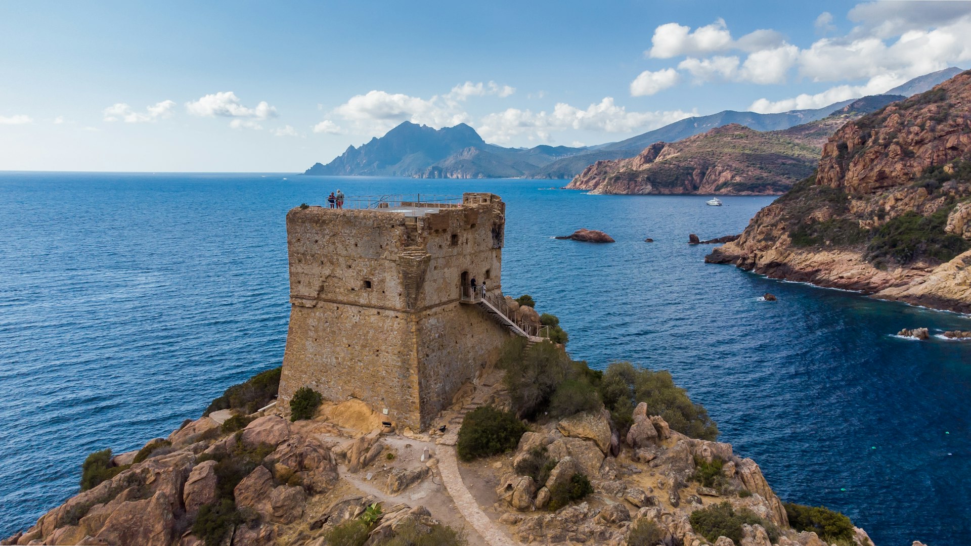 Aerial view of the ruins of the square Genoese tower of Porto at the end of the Gulf of Porto, Corsica, France.