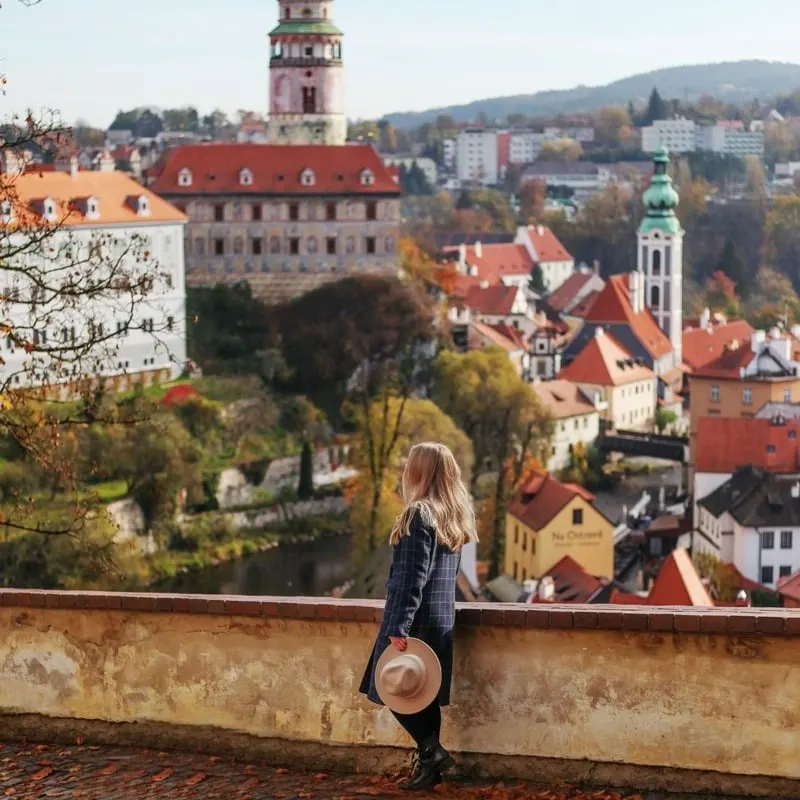 Young Female Tourist Admiring A View Of The Cesky Krumlov Old Town, South Bohemia, Czechia, Czech Republic, Central Europe