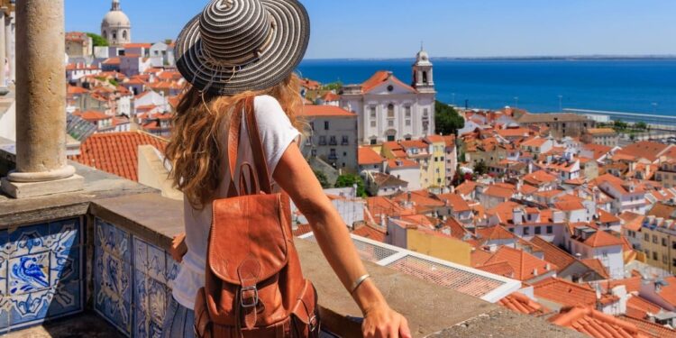 Young Woman Admiring A View Of Alfama In Lisbon