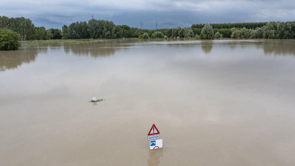 Cars are washed down the road as huge floods hit Italy and Switzerland as torrential downpours batter the continent after extreme 42C heatwave