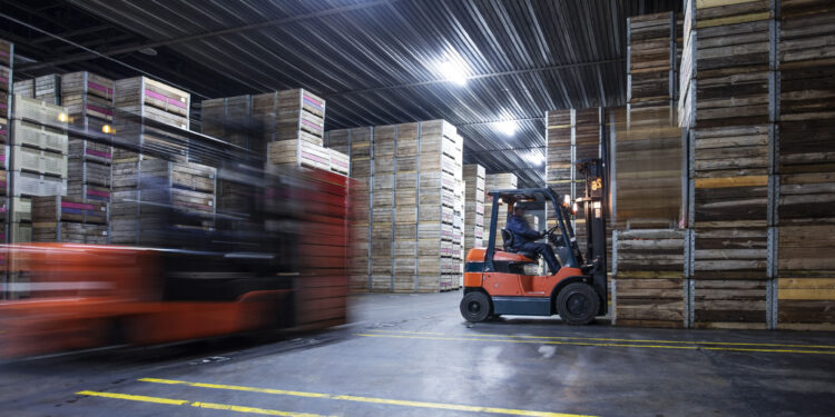 Man on forklift in factory hall