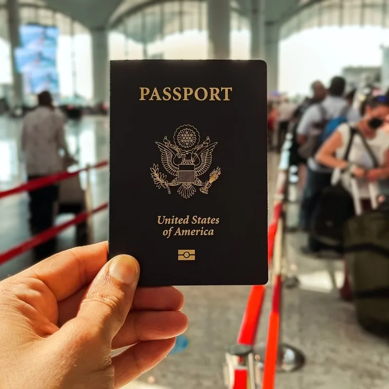 American Citizen Holding A U.S. Passport American Passport As They Wait In A Queue At The Airport