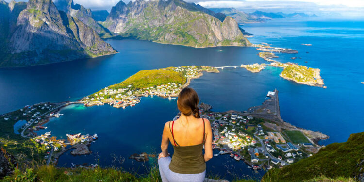 Young Woman Admiring Views Of Lofoten From A Viewpoint In Northern Norway, Scandinavia, Northern Europe.jpg