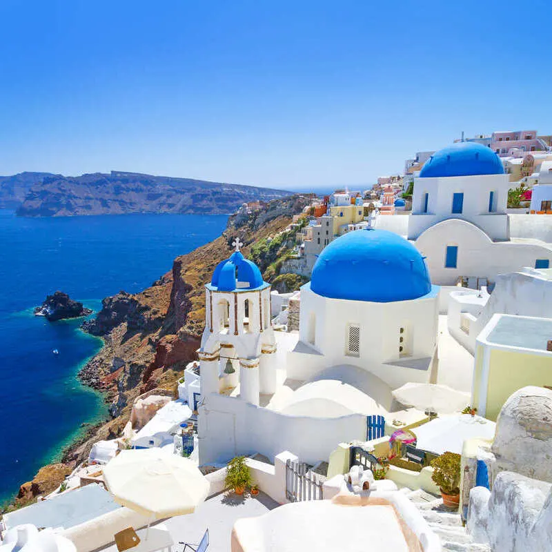 Panoramic View Of Whitewashed Village Of Oia, In The Island Of Santorini, Greece, South Eastern Europe