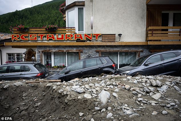 Cars inside the rubble from a landslide caused by severe weather following storms that caused flooding and landslide in Saas-Grund, canton of Valais, Switzerland, June 30