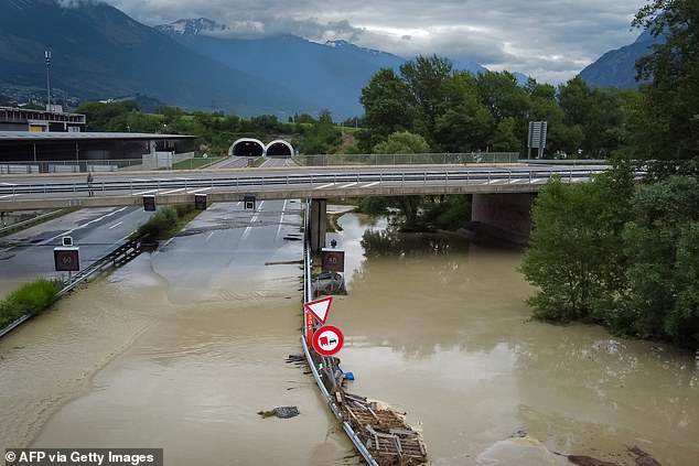 An aerial picture taken on June 30, 2024 shows the A9 motorway A9 partially flooded near Sierre, western Switzerland