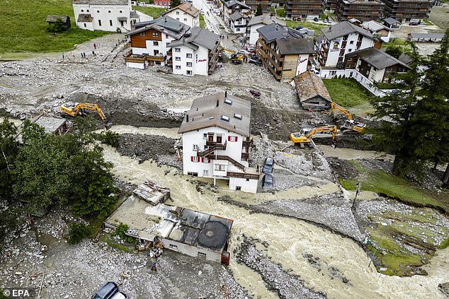 Buildings stand amid the rubble from a landslide following storms that caused major flooding in Saas-Grund, in the canton of Valais, Switzerland, June 30