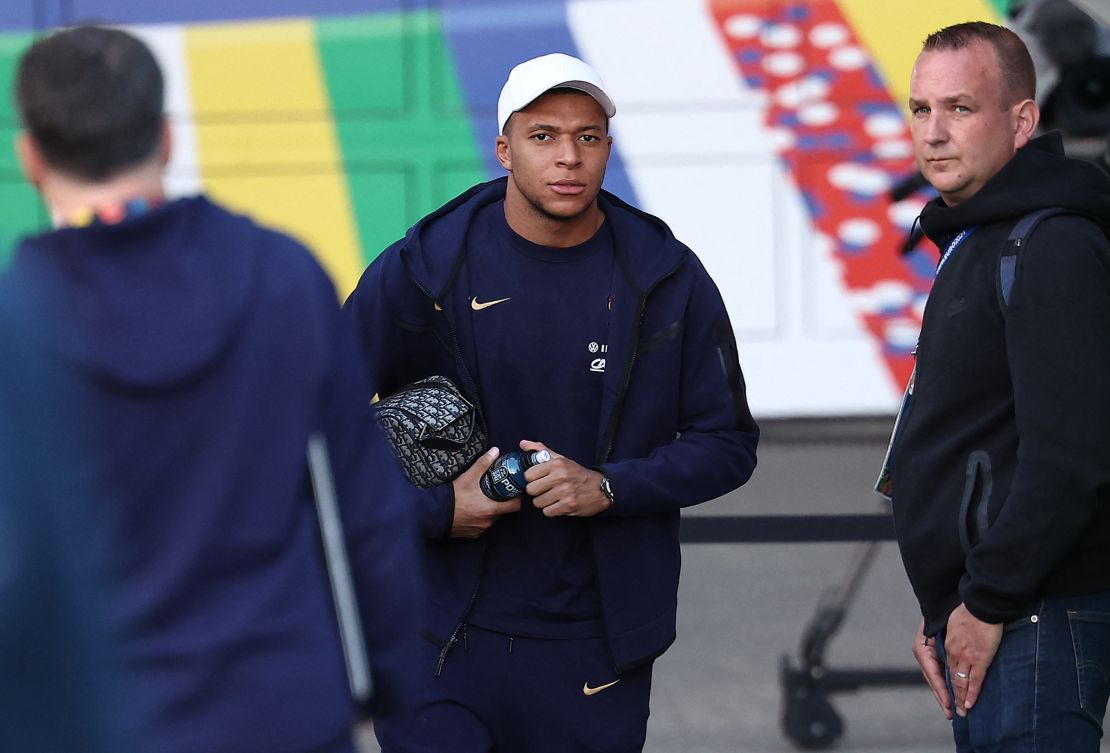 French soccer star Kylian Mbappé, center, leaves the stadium after a training session in Hamburg, Germany, on July 4, 2024.