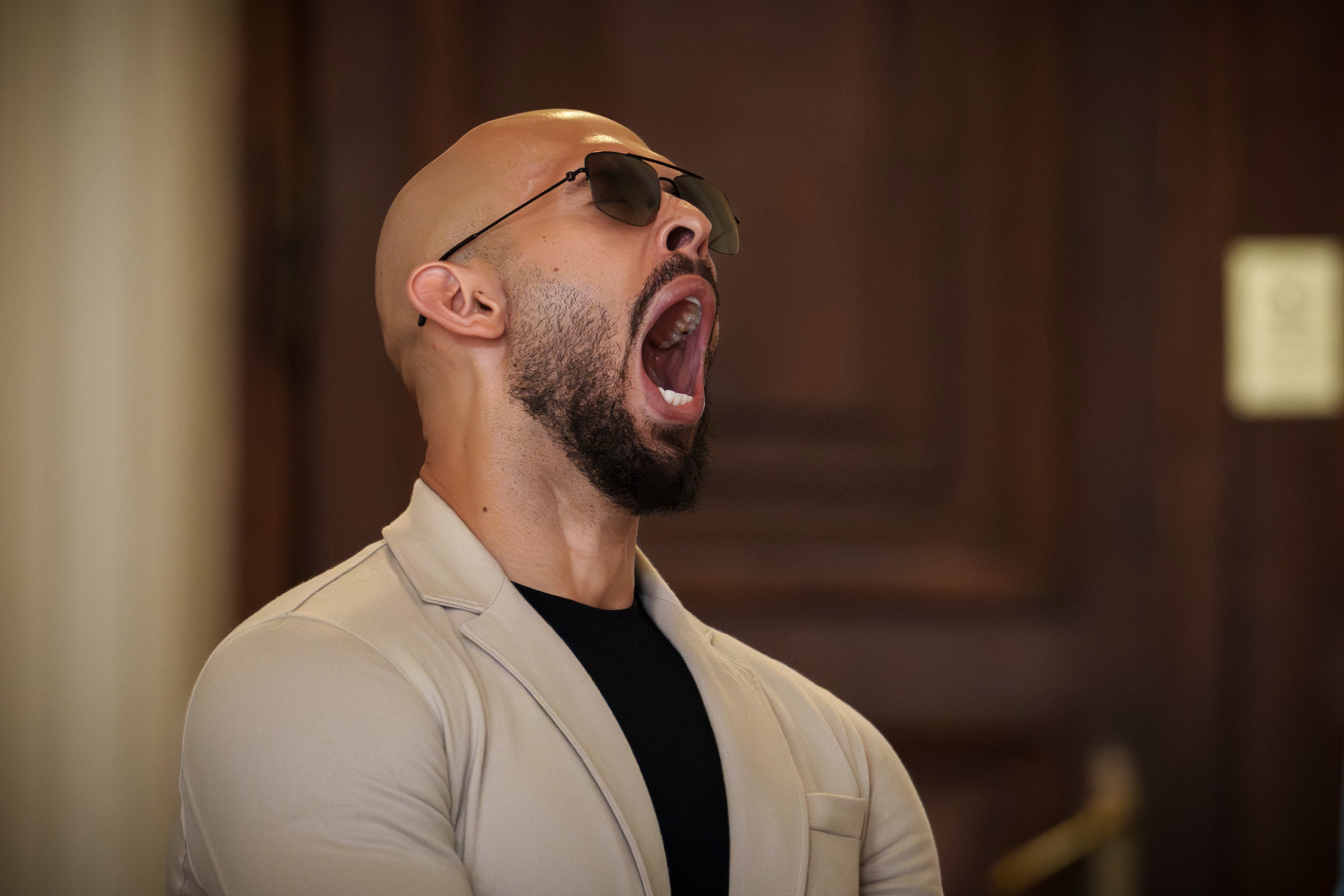 Andrew Tate yawns while waiting for his hearing inside the Court of Appeals building in Bucharest, Romania, Wednesday, 26 June 2024