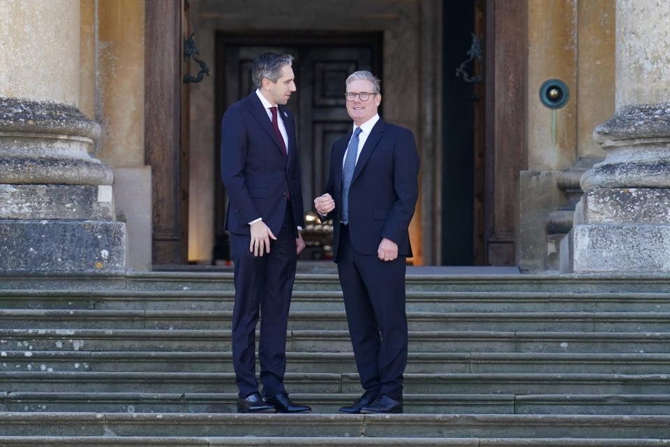 Taoiseach (Prime minister of Ireland) Simon Harris (L) is welcomed by Britain's Prime Minister Keir Starmer to the European Political Community summit at Blenheim Palace this morning (Getty Images)