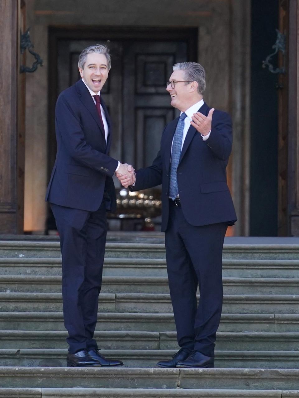 Irish Taoiseach Simon Harris is welcomed by British Prime Minister Keir Starmer to the European Political Community summit at Blenheim Palace in Woodstock, Oxfordshire (via REUTERS)