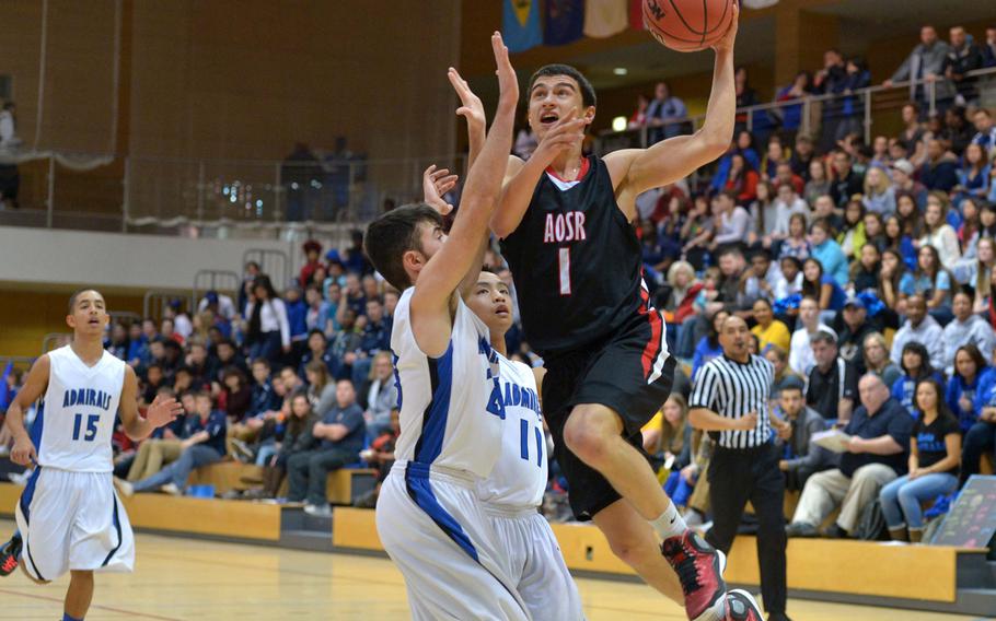 American Overseas School of Rome's Otis Reale goes to the basket against Rota's Luis Fuertes in the boys Division II championship game at the DODDS-Europe basketball championships in Wiesbaden, Germany, Saturday Feb. 21, 2015. It was the first DII title for AOSR.