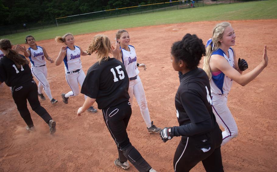 Vilseck and Ramstein high-five after the DODDS-Europe Division I softball game, which Ramstein won with a razor-thin 7-6 margin.