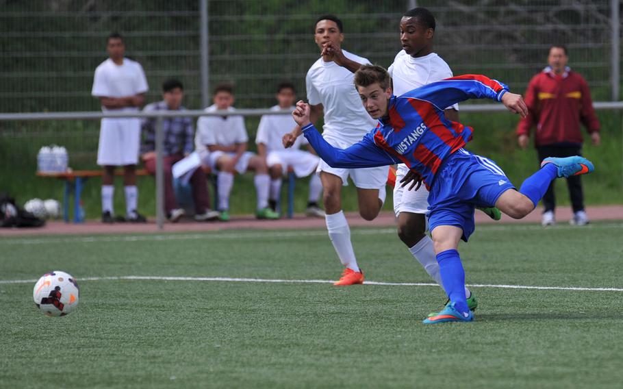 Menwith Hill's Val Evans watches his shot fly into the goal after getting past Baumholder's Jaylen Martin and Michael Majors, left, in a Division III game at the DODDS-Europe soccer championships at Landstuhl, Germany, May 19, 2015. it was Menwith Hill's final DODDS-Europe soccer tourney as the school closed at the end of the school year.