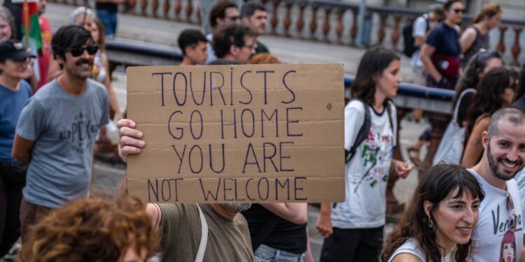 An anti-tourism placard is seen during a demonstration against mass tourism in Barcelona, Spain, earlier this month. (Paco Freire/SOPA Images/LightRocket/Getty Images via CNN Newsource)