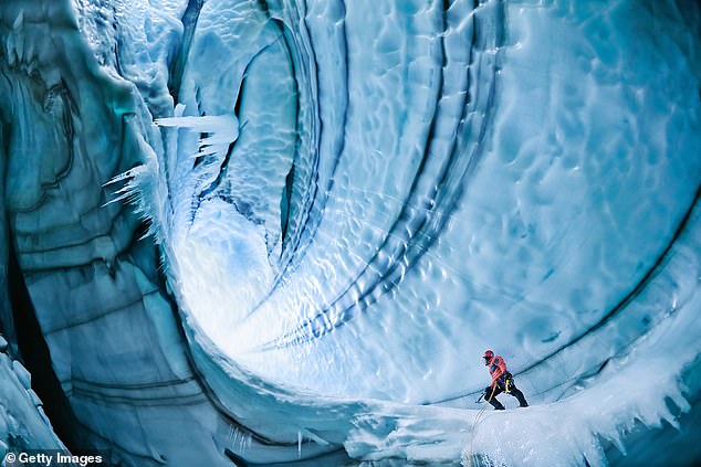 A climber under the surface of the Langjokull glacier in Iceland