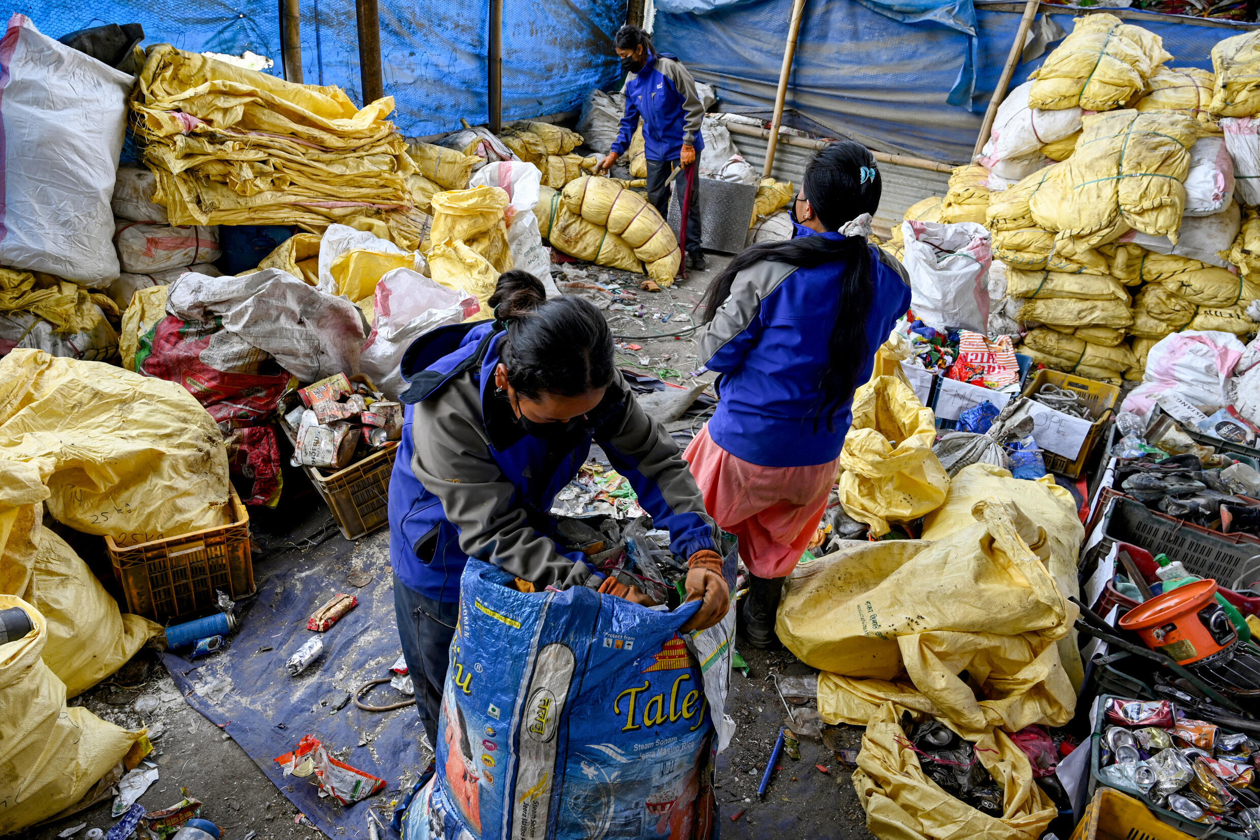 Workers segregate waste materials retrieved from Mount Everest to recycle in Kathmandu in this photograph taken on June 12, 2024.