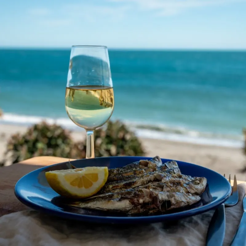 Seafood and wine on a table facing the Mediterranean Sea