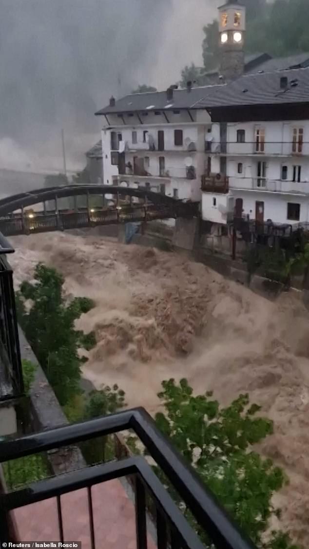 The Noaschetta river (pictured) near Turin, in northern Italy, burst its banks after more than seven inches of rain fell and unleashed a 'water bomb' on the town of Noasca causing the access bridge to be flooded and the main road to be closed