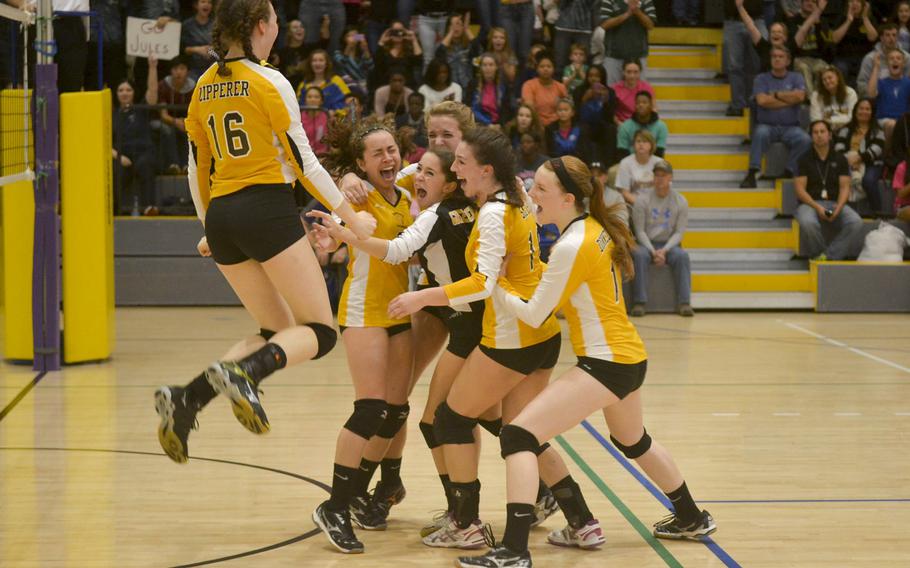 Players from the Stuttgart High School volleyball team celebrate immediately after winning the DODDS Division I championship Saturday, Nov. 7, 2015 at Ramstein Air Base, Germany.