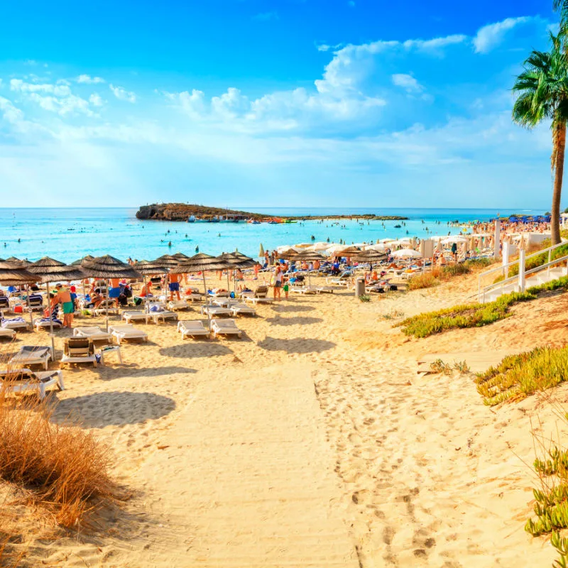 View of turquoise water Nissi beach in Aiya Napa, Cyprus. Ayia Napa coastline. Beautiful sand beach in Aiya Napa, Cyprus. Famous tourist beach in Cyprus