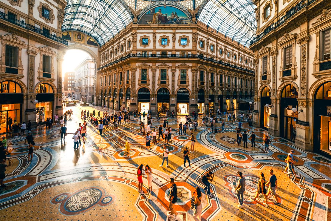 The sun sets in Milan as people stroll through Galleria Vittorio Emanuele II. Italian citizenship is especially sought after.