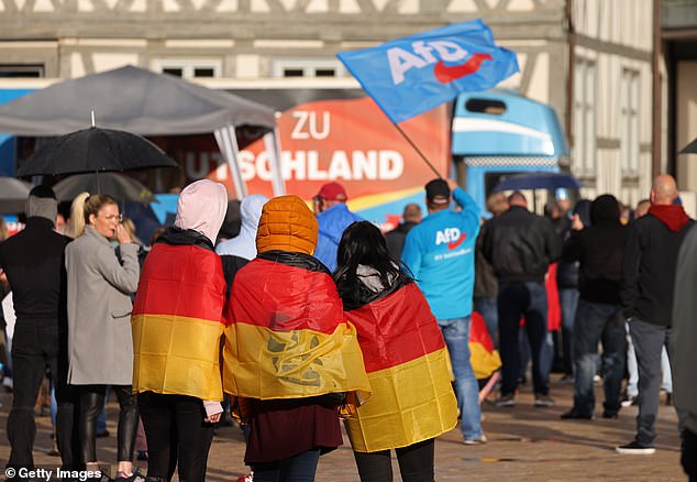 Teenage girls draped in German flags attend an election campaign rally of the right-wing Alternative for Germany on May 28