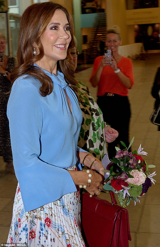 The 52-year-old royal was photographed beaming as she attended today's event in Copenhagen