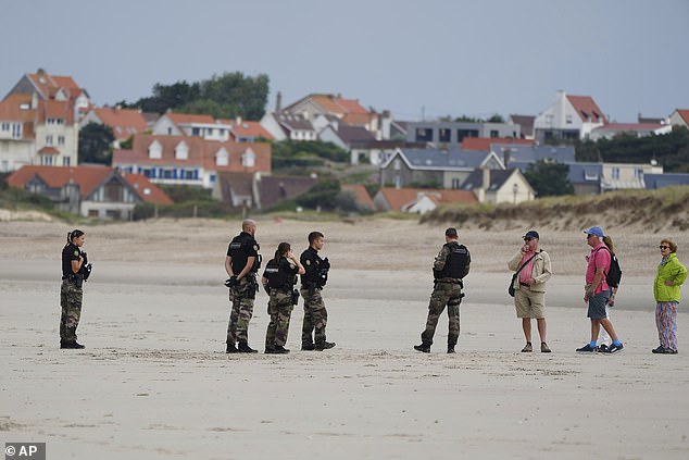 Police officers guard on the Wimereux beach, France, which is popular for migrants hoping to cross the English Channel to reach Britain, on September 4, 2024