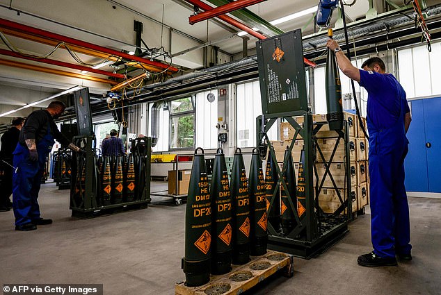 Technicians of German armaments company and automotive supplier Rheinmetall work on 155mm ammunition that will be delivered to Ukrainian Forces for the Panzerhaubitze 2000 (armoured howitzer 2000), a 155mm self-propelled howitzer, at the facility of Rheinmetall in Unterluess, northern Germany