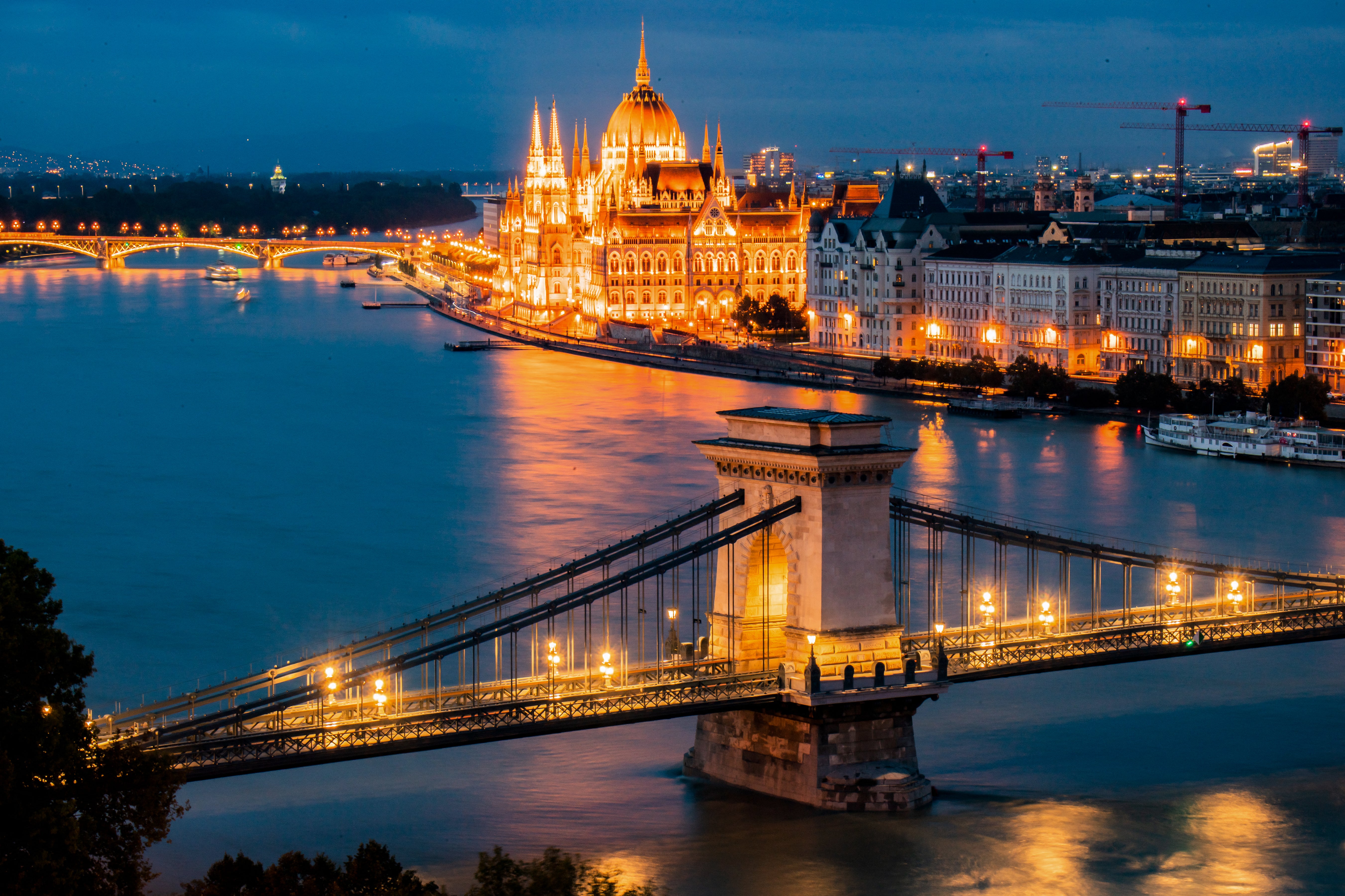 Danube river flowing past the illuminated Hungarian parliament building in Budapest on 16 September 2024