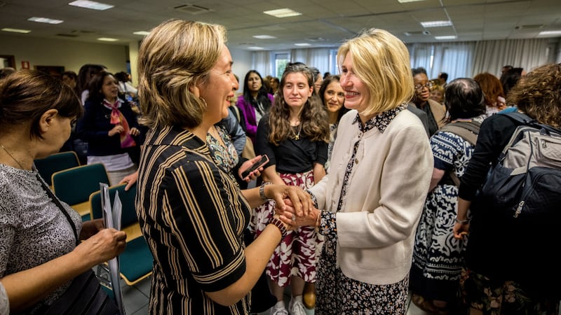 Relief Society General President Camille N. Johnson speaks with a woman after a devotional in Milan, Italy.