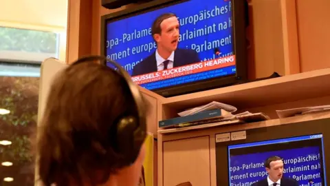 AFP/Getty Facebook founder Mark Zuckerberg on a television during his testimony to EU lawmakers May 2018