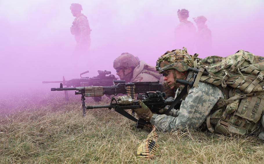 U.S. Army Cpl. Austin Douglas, front, and Pvt. Thomas Bryd, both with 2nd Armored Brigade, 3rd Infantry Division, maintain a defensive position during a NATO drill at Bemowo Piskie Training Area in Poland on March 11, 2024.