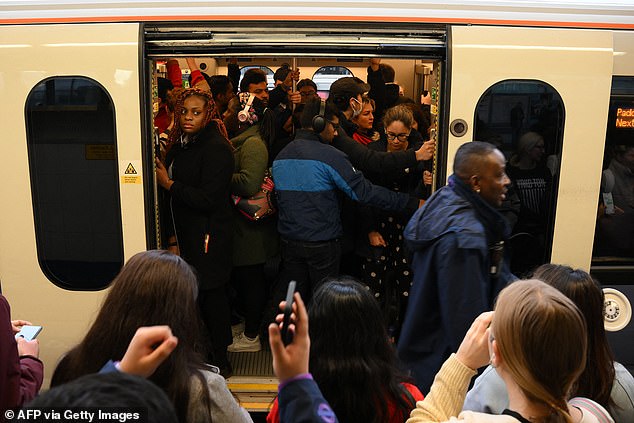 Commuters on board a packed Jubilee line train at Stratford station in December 2021