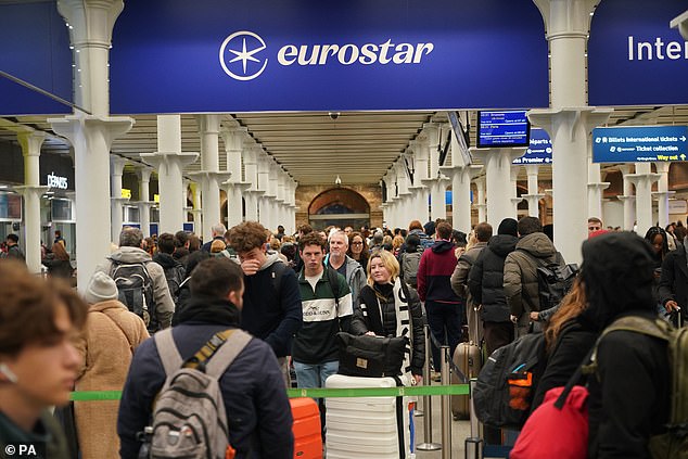 Passengers queue at the entrance to Eurostar at London St Pancras station last December