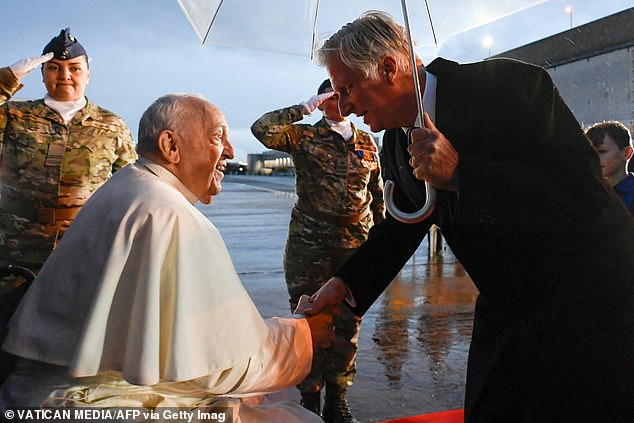 King Philippe, 64, shook the hand of Pope Francis as he welcomed the leader of the Catholic Church to his nation