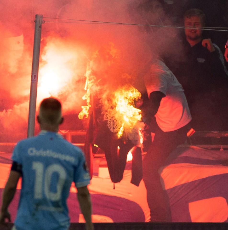 Malmo fans butn a Rangers supporter's hoodie