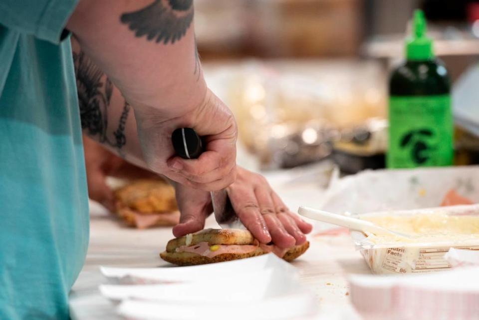 An employee prepares a sandwich at Tavi’s Salumeria in Gulfport on Thursday, Sept. 19, 2024.