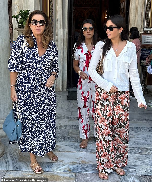 Alexia, pictured, sported chic sunglasses and held onto a handbag to accessorise her navy and white dress