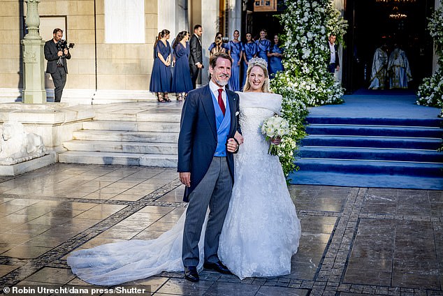 Princess Theodora of Greece and Crown Prince Pavlos pose for pictures outside the venue