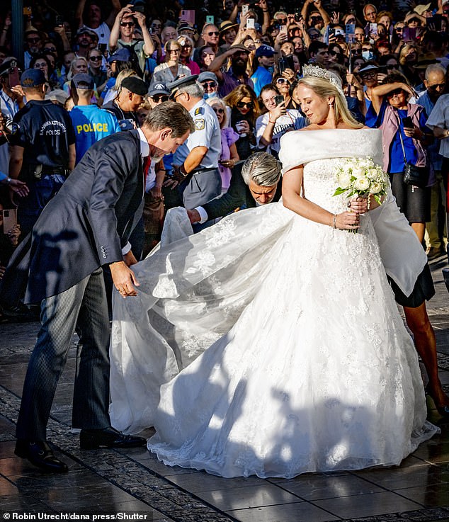 In one moment, Crown Prince Pavlos adjusted the bride's Celia Kritharioti gown