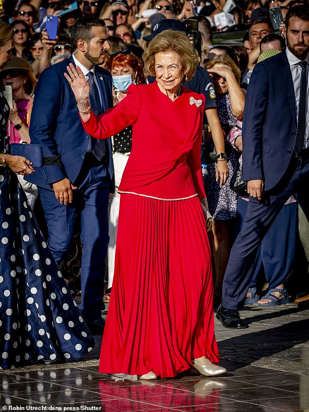 Queen Sofia of Spain attends the wedding of her niece in Athens, sporting a glamorous red frock for the glitzy occasion