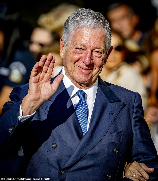 Crown Prince Alexander of Serbia waves to the crowd whilst donning a a dark navy suit